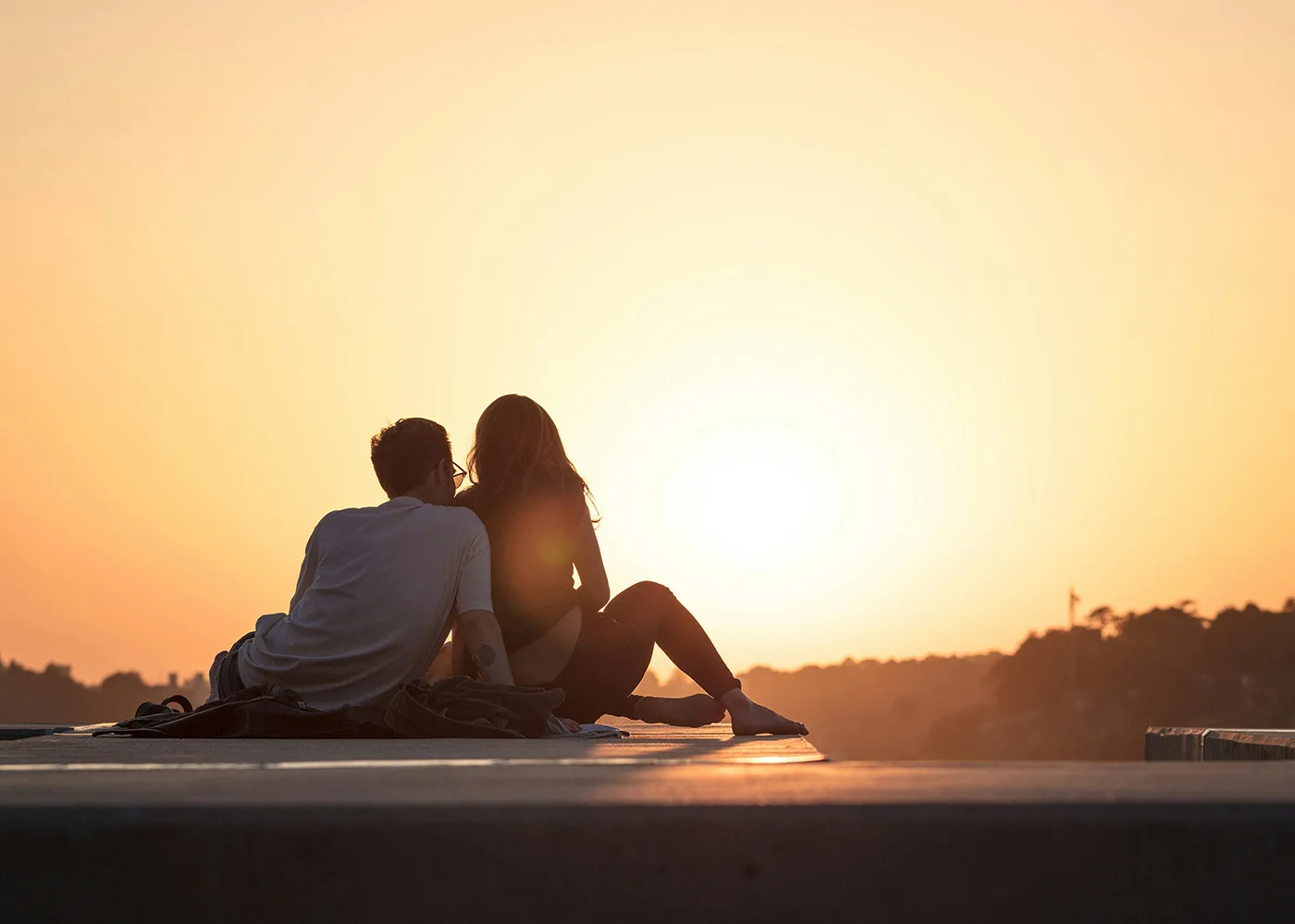 Young couple watching the sunset.